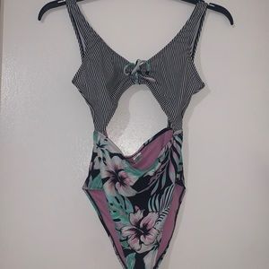 Woman’s flowery one piece with cut out front and back super cute never worn